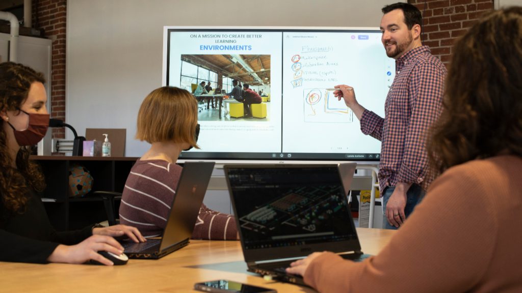 A team uses the Vibe smart board during a collaborative meeting.
