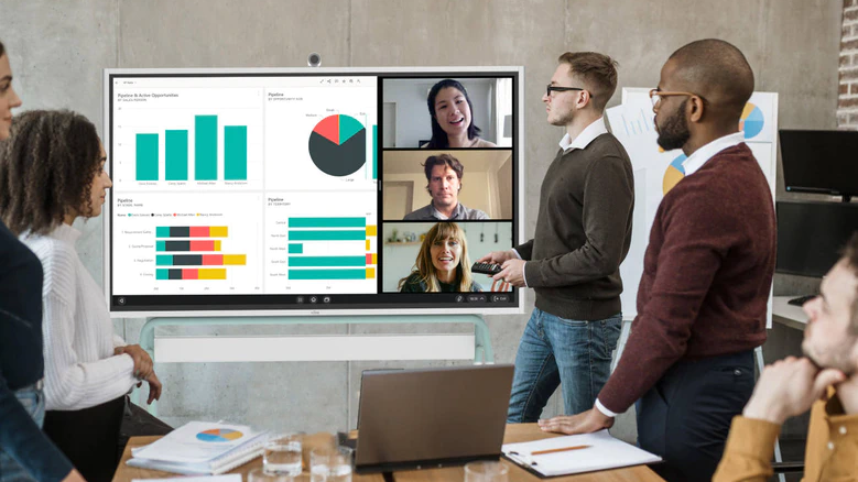 Government officials using a Vibe interactive whiteboard to review project plans and data in a secure meeting environment, enabling collaborative decision-making and information sharing across departments while maintaining compliance protocols.