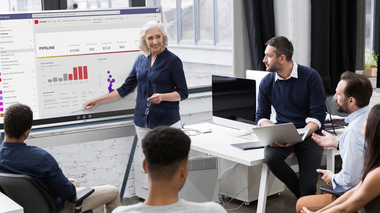 Professional services team using a Vibe interactive whiteboard to analyze client data and develop strategic recommendations, facilitating collaborative problem-solving and efficient workflow management in a modern consulting environment.
